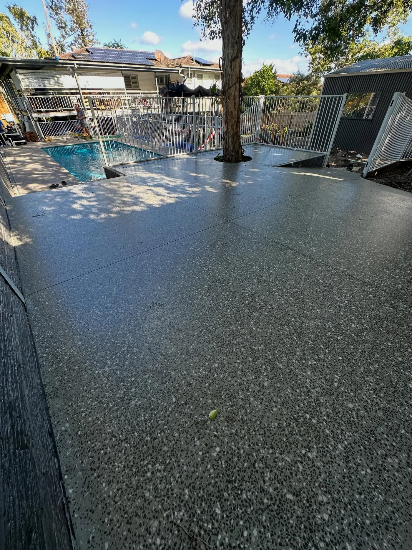 Completed dark speckled floor finish in a garage or workshop