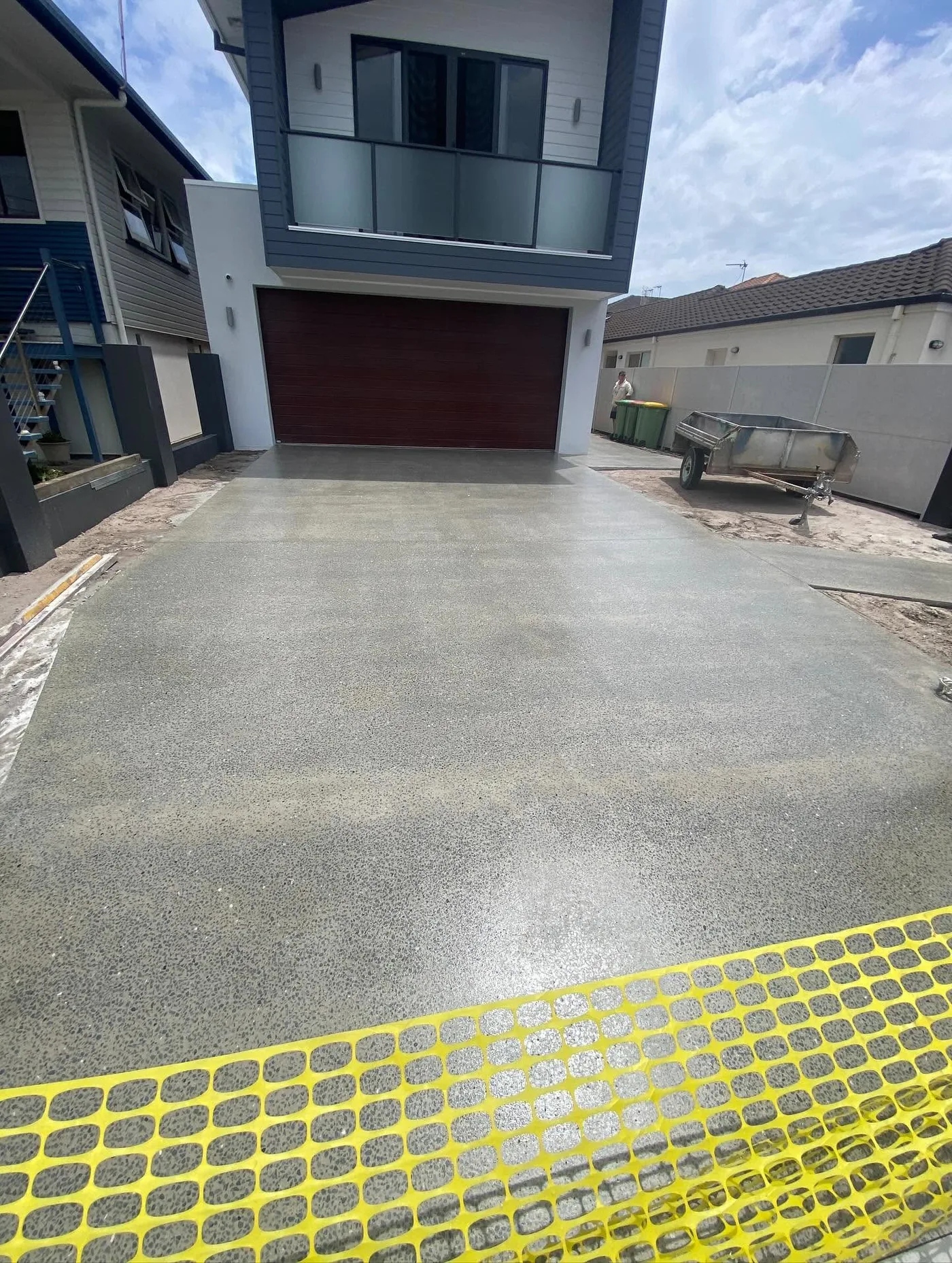 Completed grey concrete surface on a residential driveway