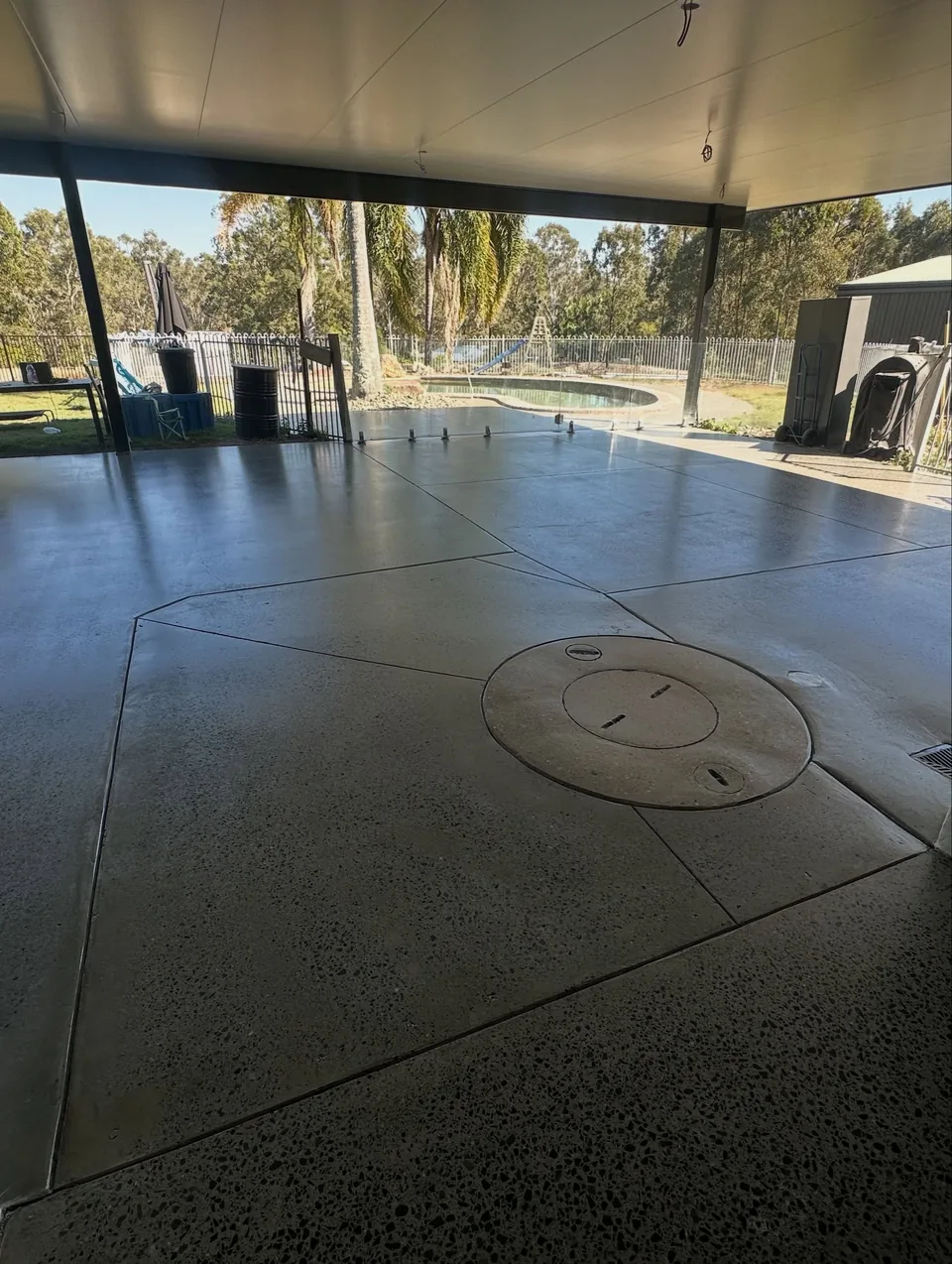 Honed and sealed concrete floor beneath a covered outdoor entertaining area