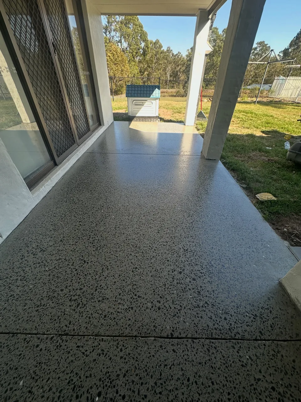 Covered patio with a honed and sealed concrete finish after covercrete removal