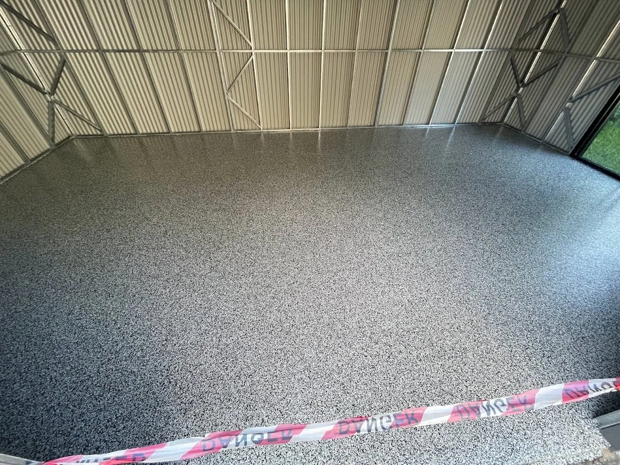 Completed speckled floor system inside a workshop